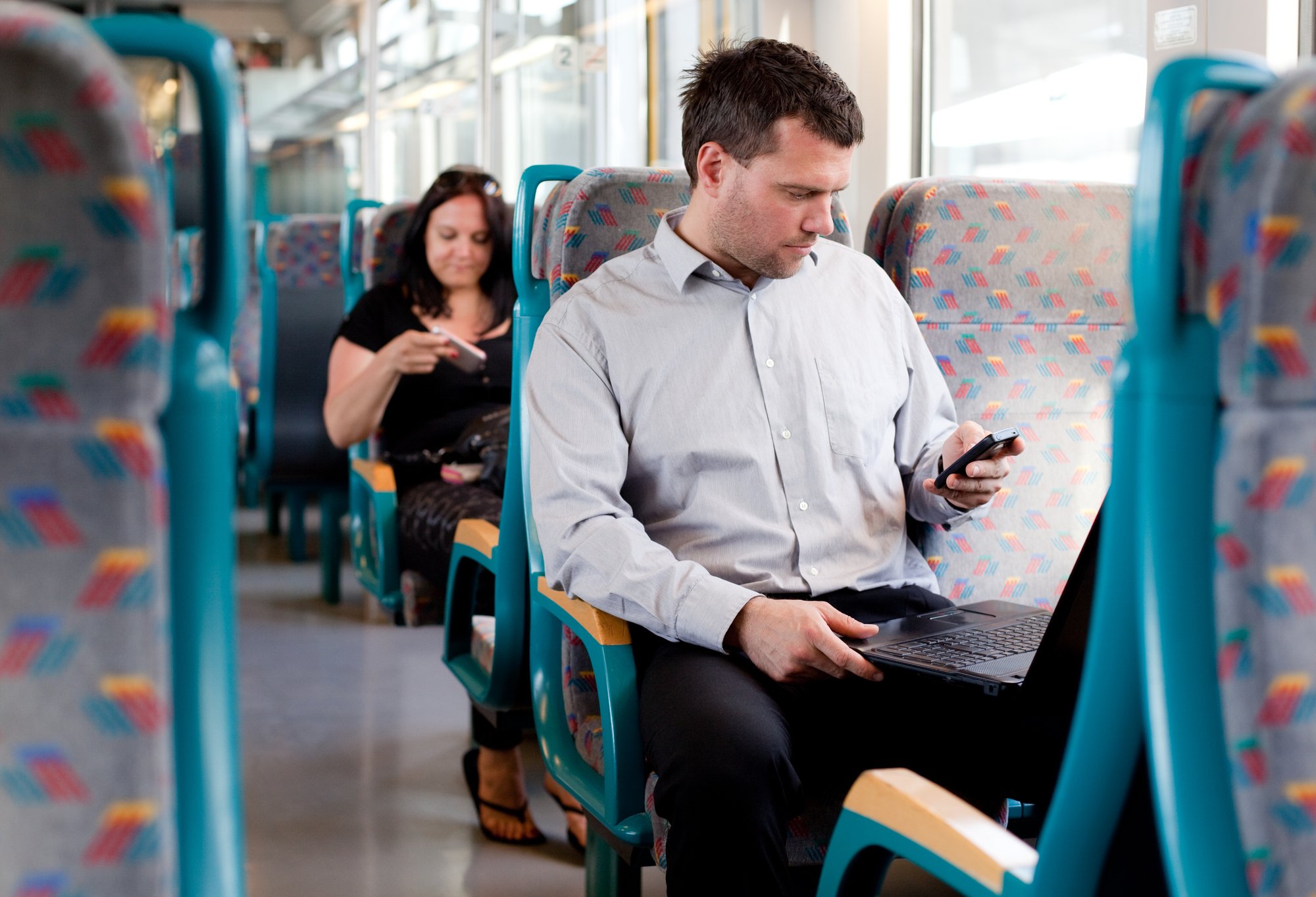 Candid image of a businessman working on a train
