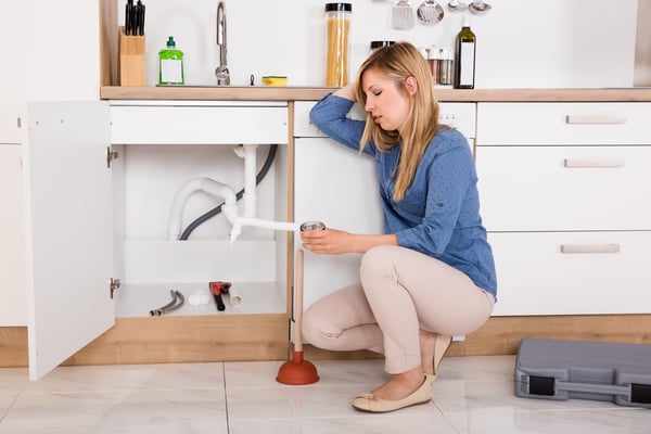 woman having trouble with sink.