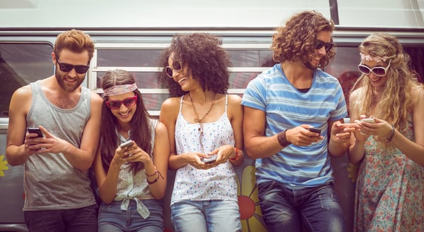 Millennial friends using their phones