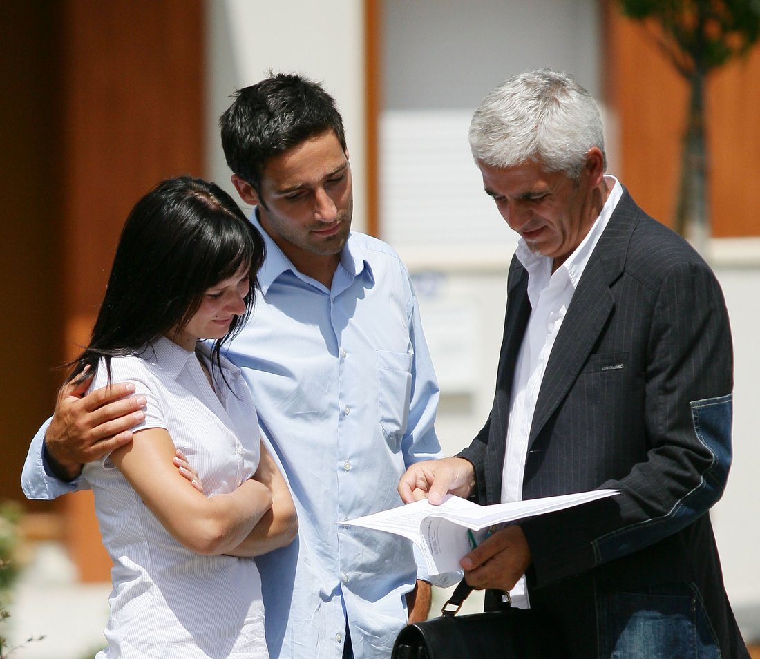 Estate-agent about to show couple around property-1