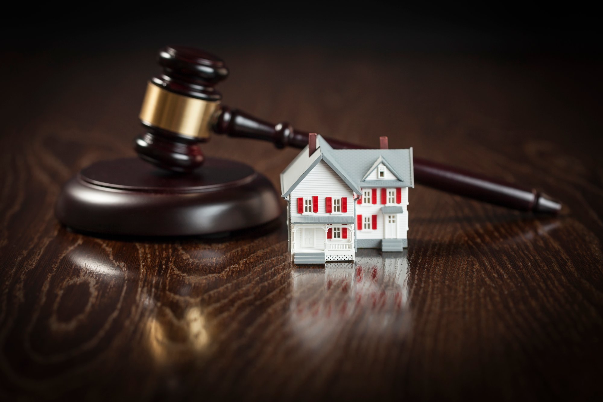 Gavel and Small Model House on Table