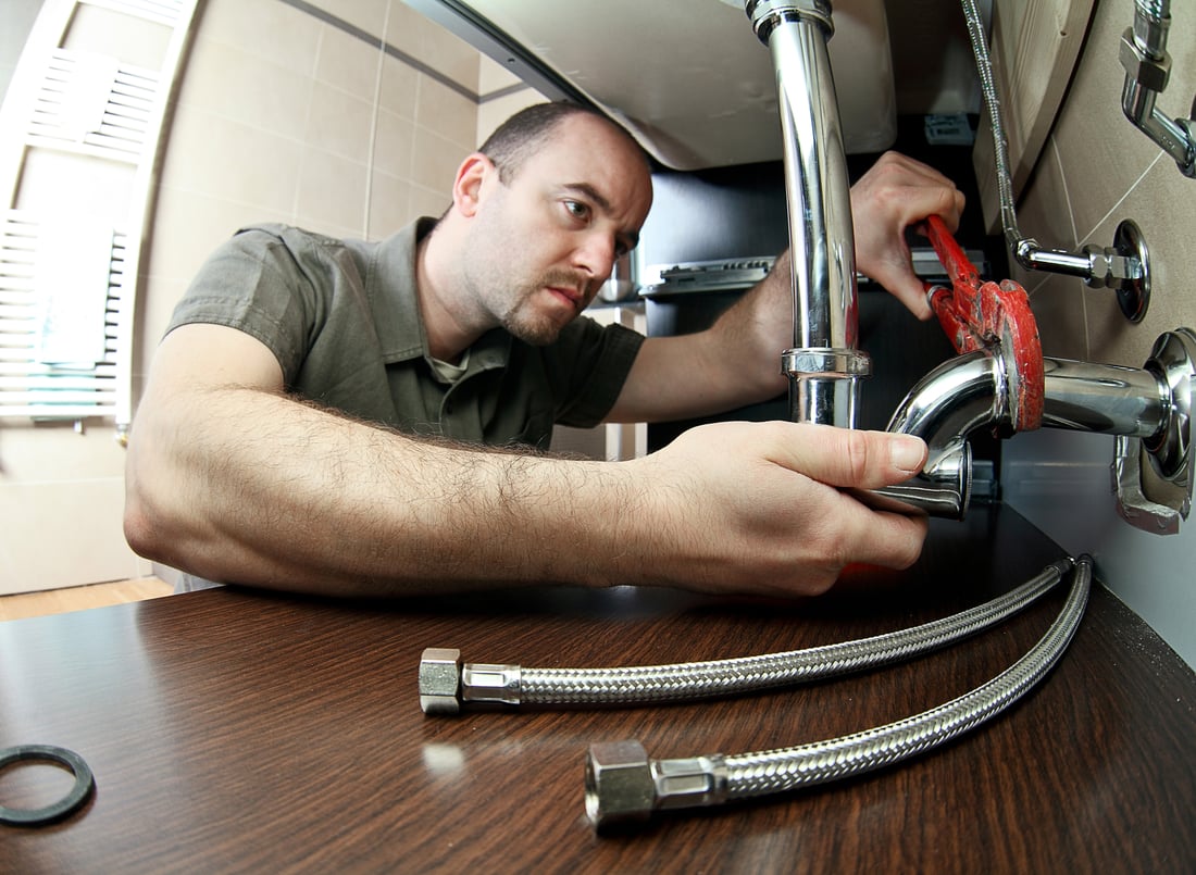 Plumber working on pipe